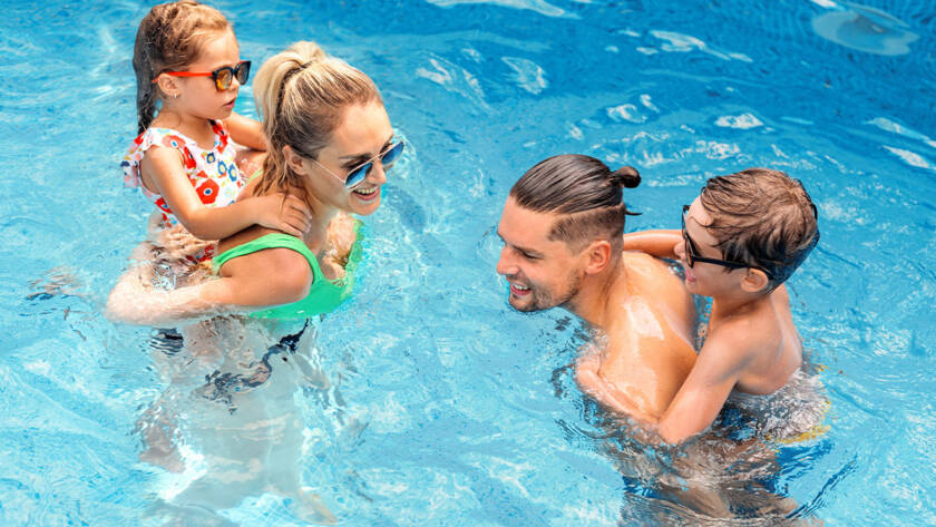 Private swimming training in Dubai with certified coach guiding a swimmer in a modern swimming pool