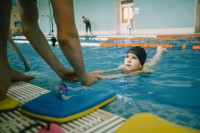 Children learning swimming with professional coaches at Larsson Swim Academy Dubai